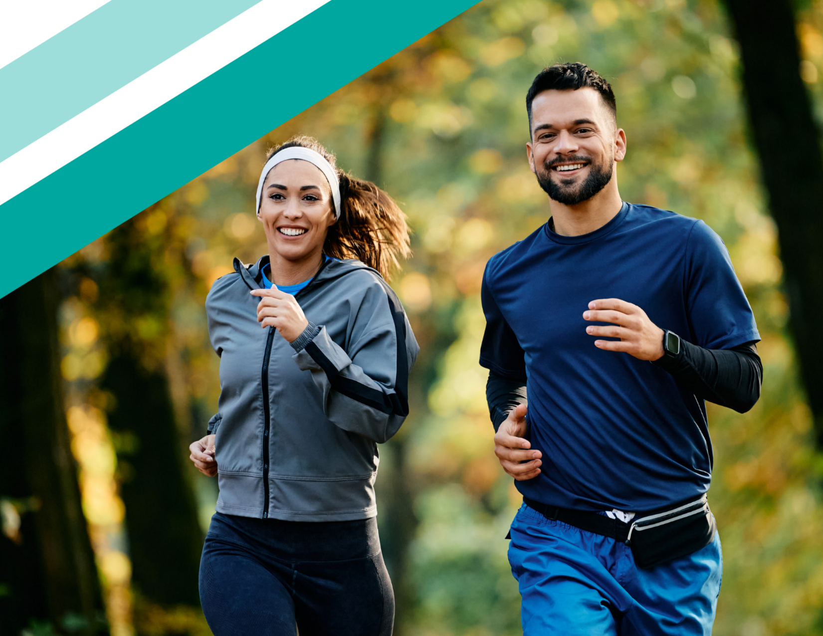 Two runners, a man and a woman, jogging together on a sunlit park path, smiling and laughing side by side.